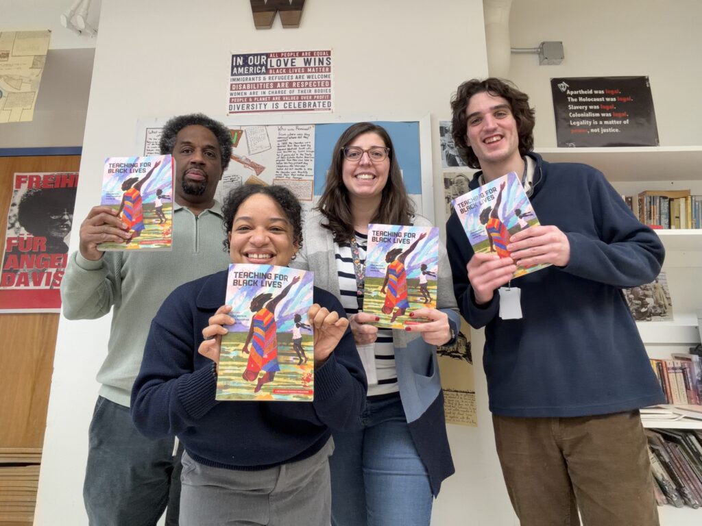 Educators smiling with books